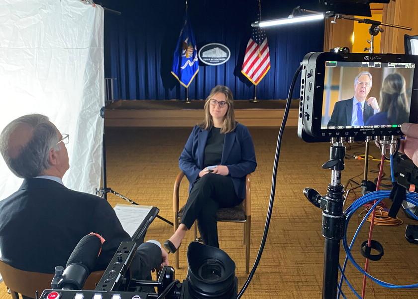 NWU student conducts video interview with State Department employee.